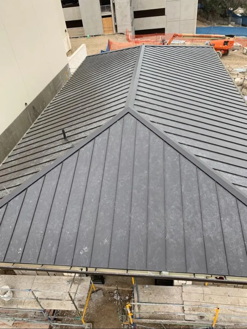 Commercial metal roof construction with crane equipment in Addis